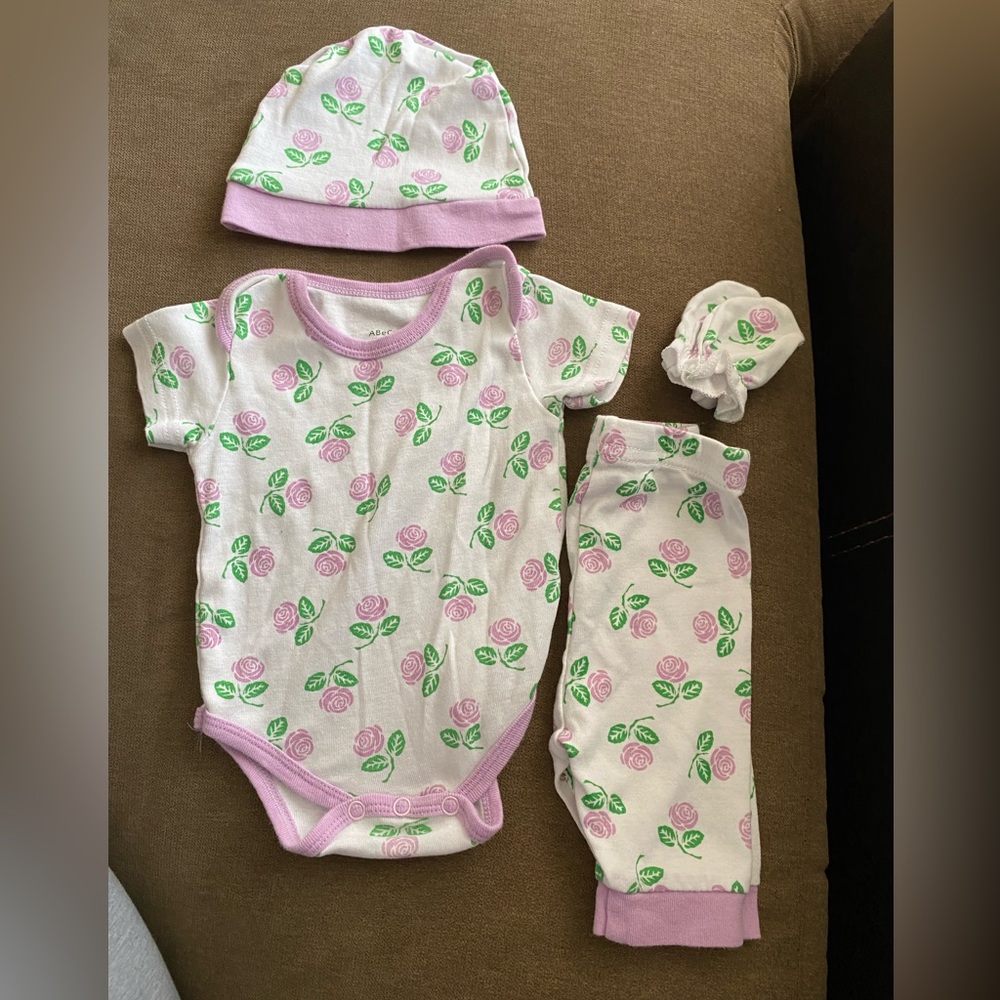 Girls 0 to 3 months matching 4 piece onesie set.